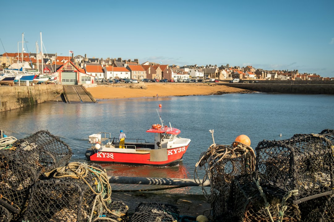 a small red boat sitting in the water